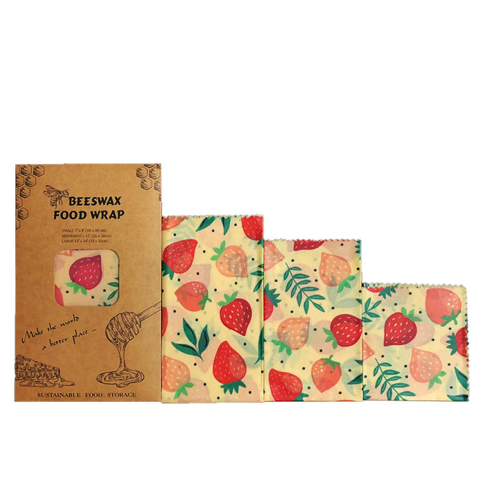 Set of three beeswax food wraps with strawberry pattern on a white background