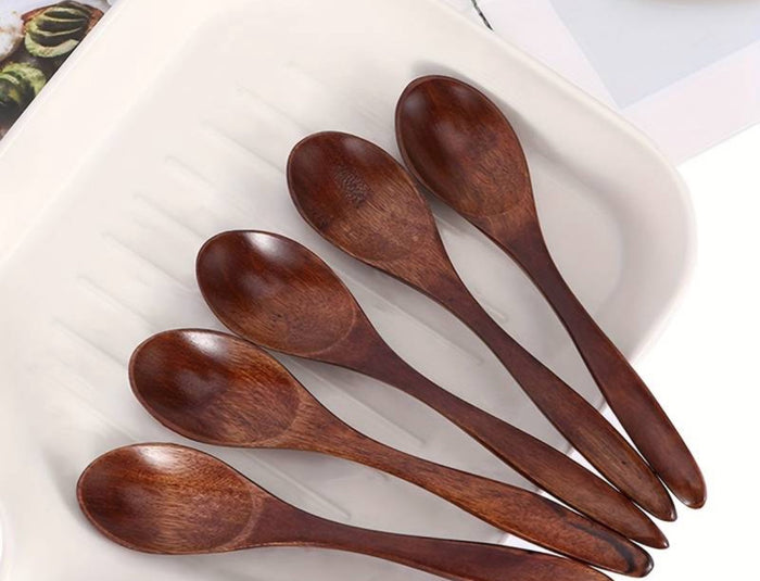 Set of wooden spoons on a white plate