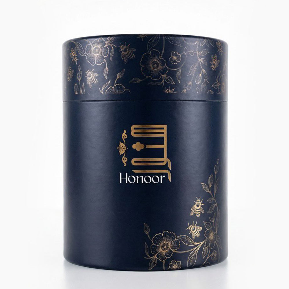 Navy cylindrical container with gold floral patterns and 'Honoor' branding on a white background

