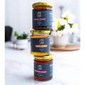 Three jars of Samar Honey stacked on a marble surface with a blurred indoor background.


