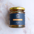 Jar of Sidr Honey with a blue label on a light background

