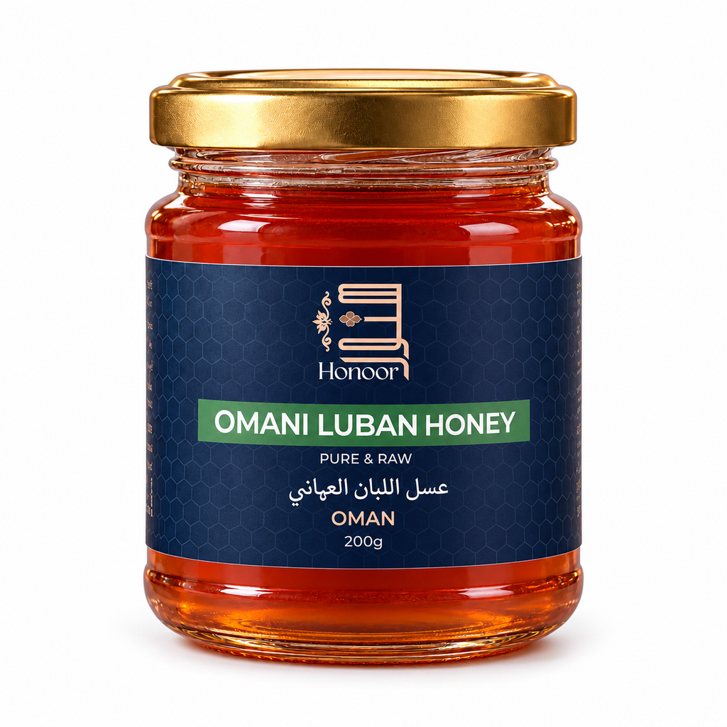 A glass jar of Honoor Omani Luban Honey with a gold metal lid and a navy blue label, set against a plain white background.

