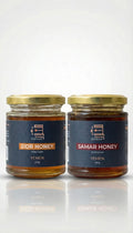 Two jars of honey from Yemen on a white background

