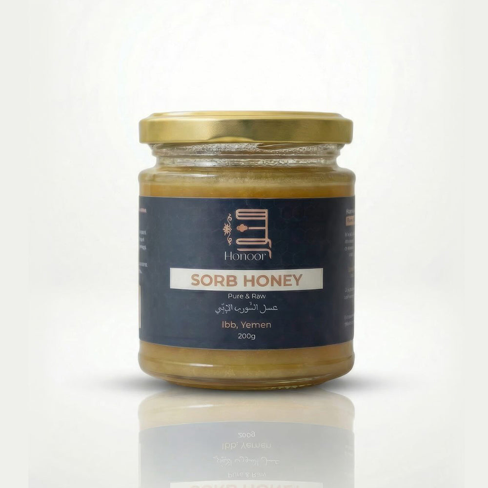 Jar of sorb honey with a blue label on a white background


