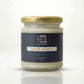 Jar of sorb honey with a gold lid on a white background