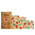 Set of three beeswax food wraps with strawberry pattern on a white background

