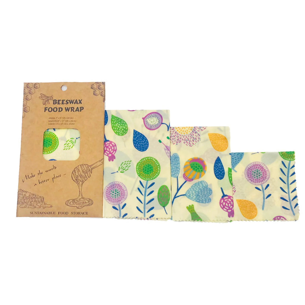 Set of beeswax food wraps with floral designs and packaging on a white background

