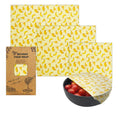 Set of beeswax food wraps with banana pattern on a white background

