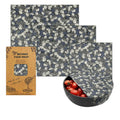 Set of beeswax food wraps with a pattern and a box labeled 'Beeswax Food Wrap' on a white background.

